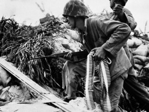 FILE - In this Dec. 1943 file photo, two Marines participate in bitter fighting on Tarawa. A U.S. military team returned from the remote Pacific atoll of Tarawa this week with the remains of what are believed to be two U.S. servicemen who died in a fierce World War II battle there. A C-17 plane returned to Hickam Air Force Base with the remains Monday, Sept. 20, 2010 after a 6 1/2-week excavation mission, joint POW/MIA Accounting Command spokesman Maj. Ramon Osorio said Wednesday.   (AP Photo, File)